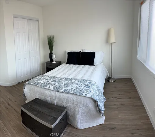 a bedroom with a bed and a night stand