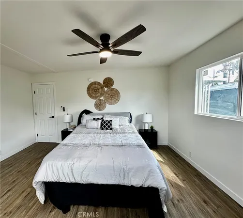 a bed sitting in a bedroom next to a window