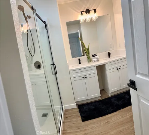 a bathroom with a sink a mirror and a shower