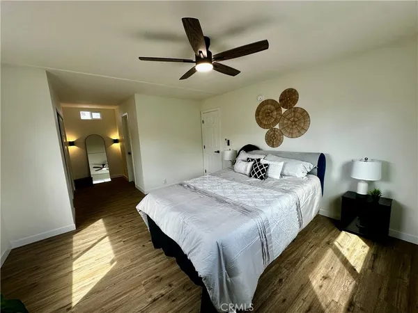 a bedroom with a bed and a chandelier
