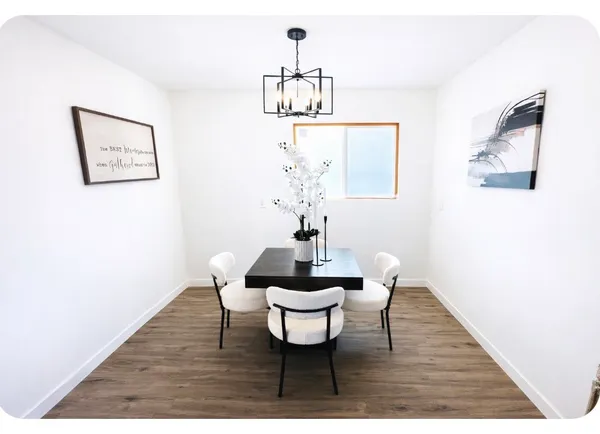 a dining room with a wooden table and chairs