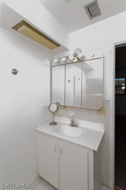 360 Bayland Road Fort Myers Beach, FL 33931 - Photo 15 of 35 a bathroom with a sink and a mirror