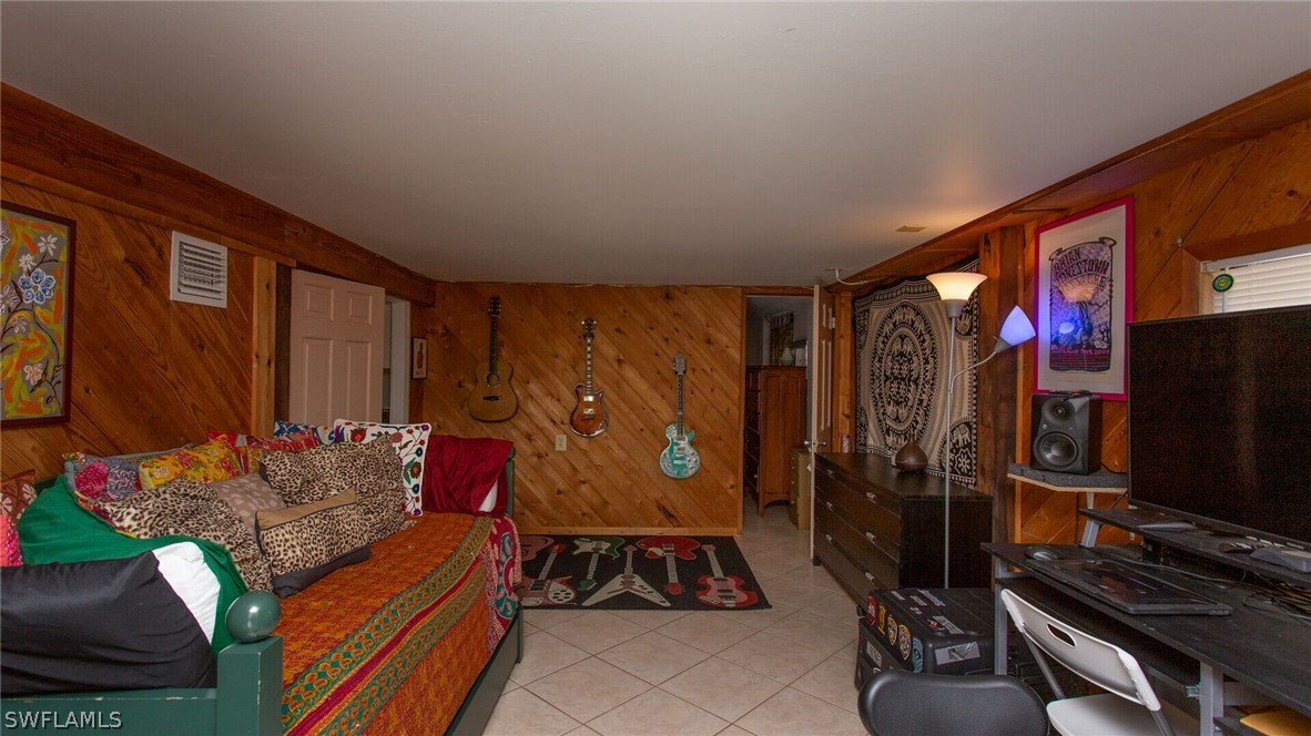 360 Bayland Road Fort Myers Beach, FL 33931 - Photo 19 of 35 a living room with furniture and a flat screen tv