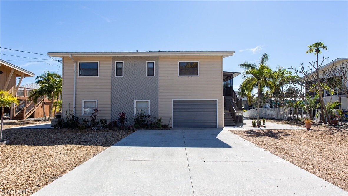 360 Bayland Road Fort Myers Beach, FL 33931 - Photo 2 of 35 a building exterior with furniture and a potted plant