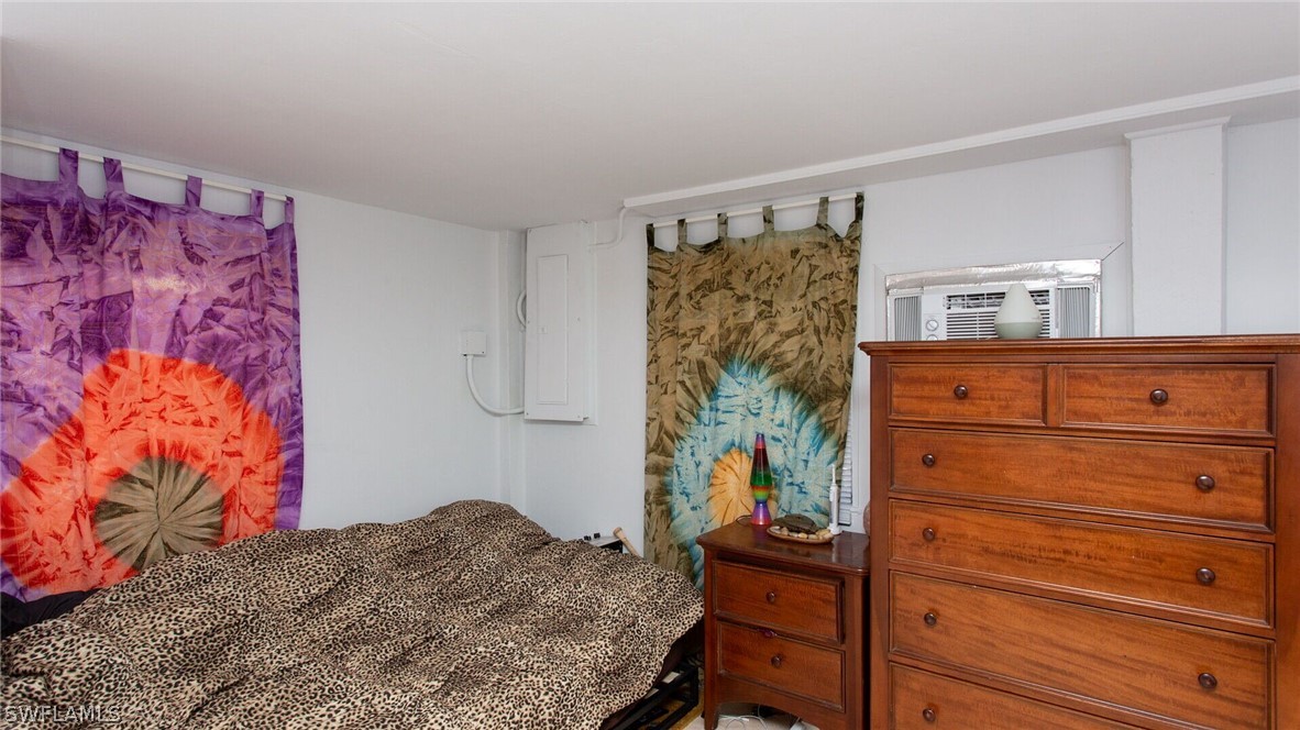 360 Bayland Road Fort Myers Beach, FL 33931 - Photo 21 of 35 a bedroom with a bed and a dresser in it