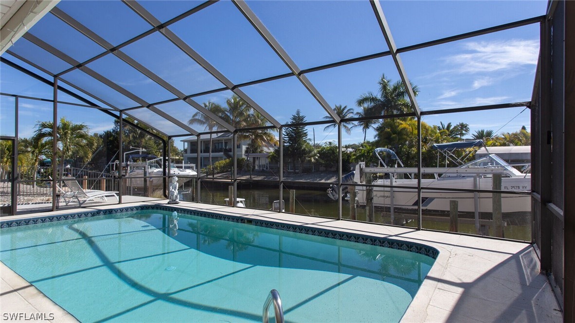 360 Bayland Road Fort Myers Beach, FL 33931 - Photo 26 of 35 a view of a swimming pool with a patio
