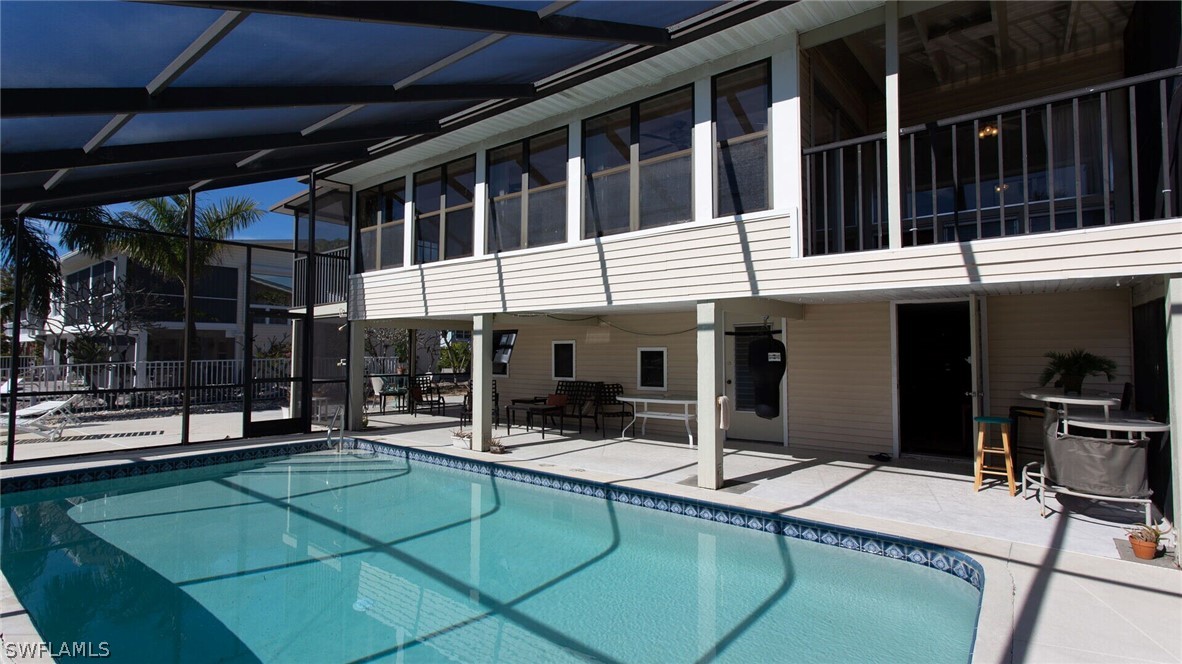 360 Bayland Road Fort Myers Beach, FL 33931 - Photo 27 of 35 a dinning table in front of a house