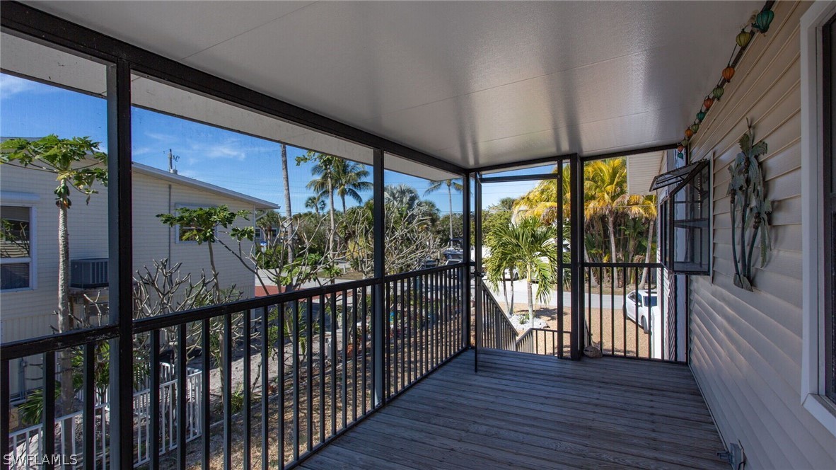 360 Bayland Road Fort Myers Beach, FL 33931 - Photo 3 of 35 a view of a porch with wooden floor and outdoor space