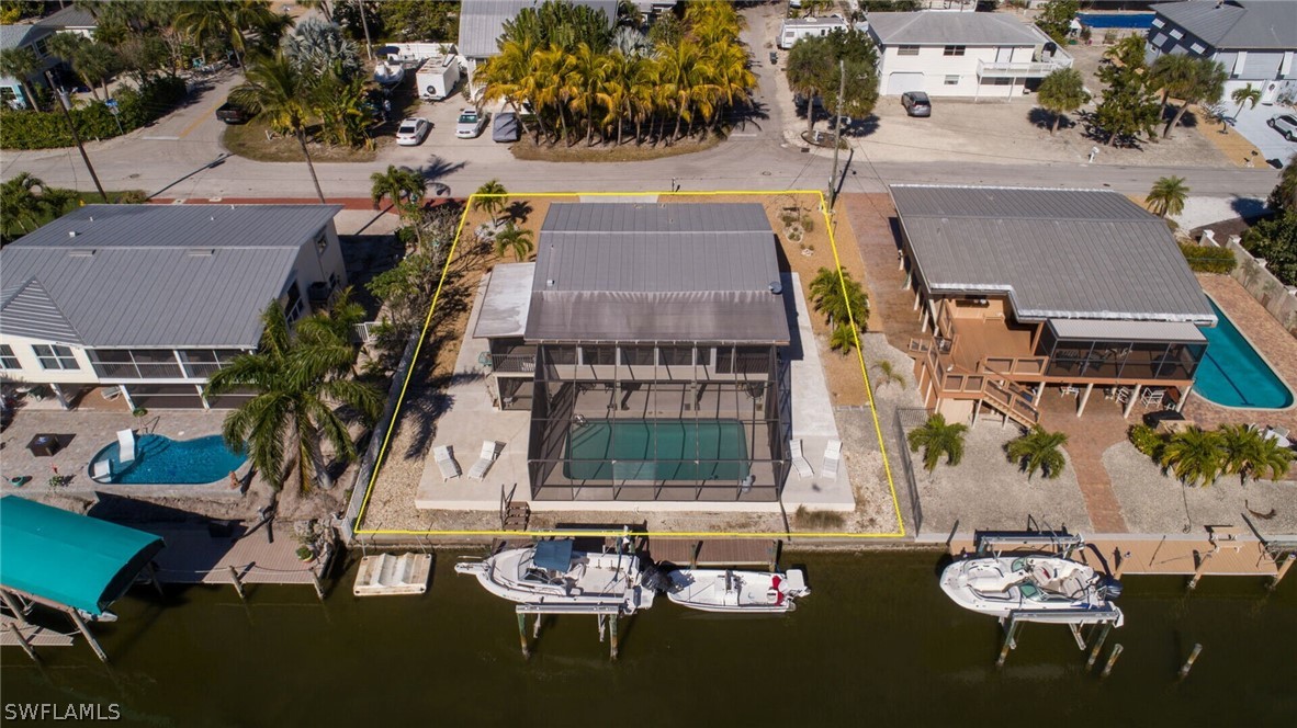 360 Bayland Road Fort Myers Beach, FL 33931 - Photo 35 of 35 an aerial view of a house with swimming pool and outdoor seating