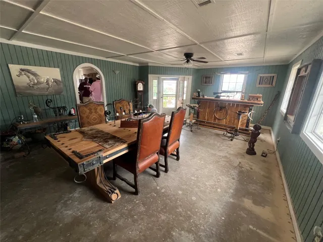 a living room with furniture a table and wooden floor