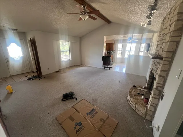 a view of a livingroom with furniture and a window