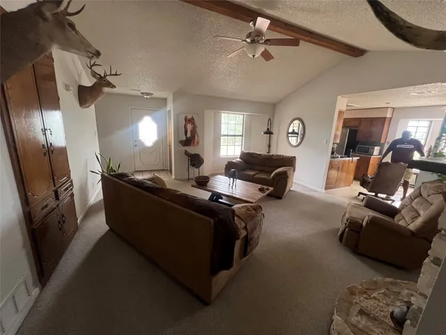 a living room with furniture and a mirror