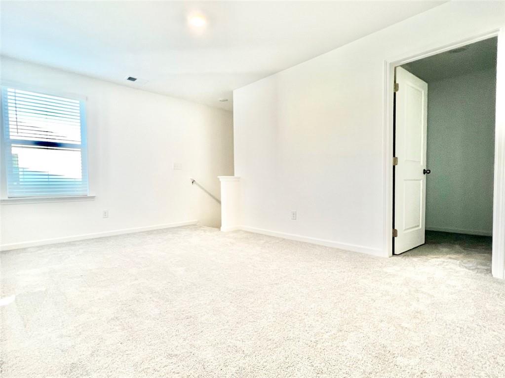 1529 Hay Patch Lane Loganville, GA 30052 - Photo 11 of 24 an empty room with a natural light