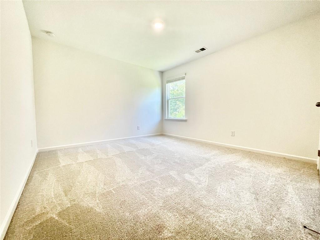 1529 Hay Patch Lane Loganville, GA 30052 - Photo 21 of 24 a view of an empty room and a window
