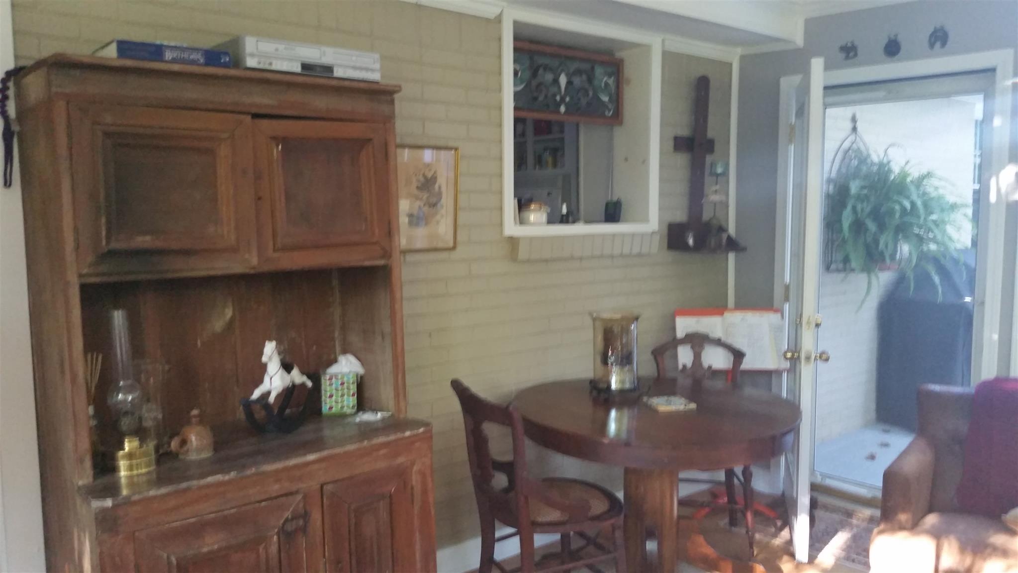 7816 Chester Road Fairview, TN 37062 - Photo 14 of 26 a kitchen with a table chairs and cabinets