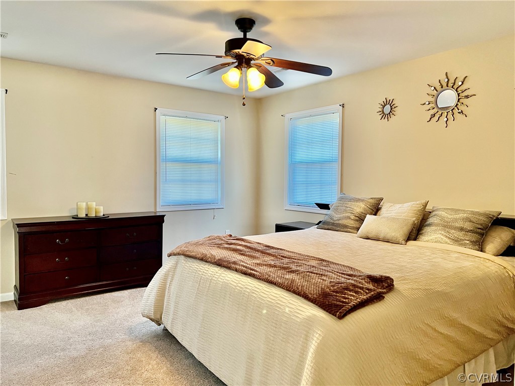 16714 Harrowgate Road Colonial Heights, VA 23834 - Photo 29 of 39 a bedroom with a bed and a chandelier fan
