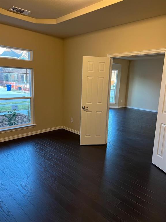 504 Christie Crossing Celina, TX 75009 - Photo 16 of 24 a view of an empty room with wooden floor and a window