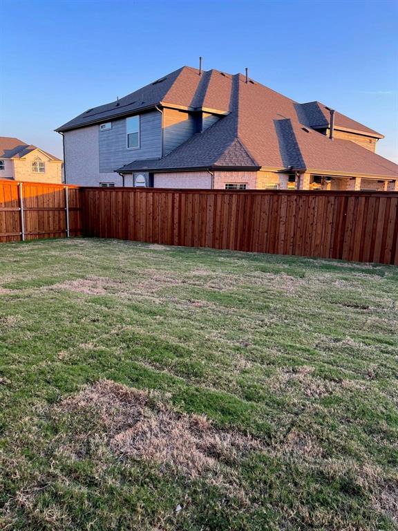 504 Christie Crossing Celina, TX 75009 - Photo 17 of 24 a view of a backyard with wooden fence