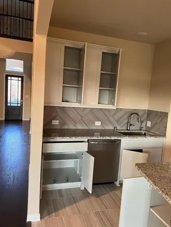 a view of empty room with wooden floor and fireplace