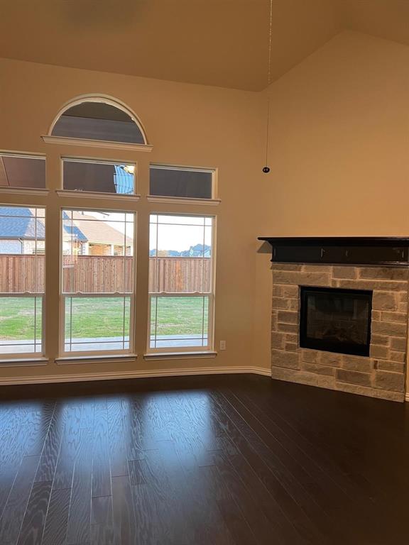 504 Christie Crossing Celina, TX 75009 - Photo 22 of 24 a view of empty room with wooden floor and fireplace