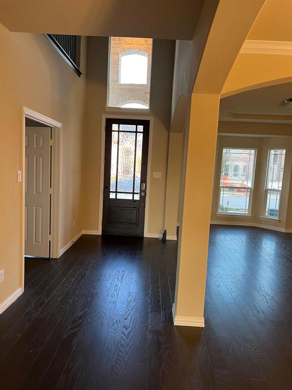 504 Christie Crossing Celina, TX 75009 - Photo 3 of 24 an empty room with wooden floor and windows