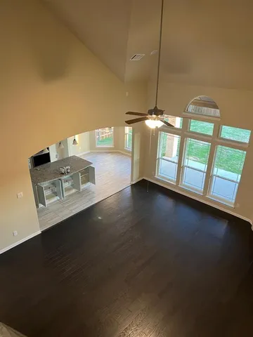 a view of a room with wooden floor and windows