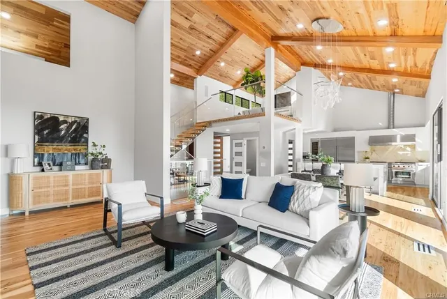 a living room with furniture and a painting on the wall