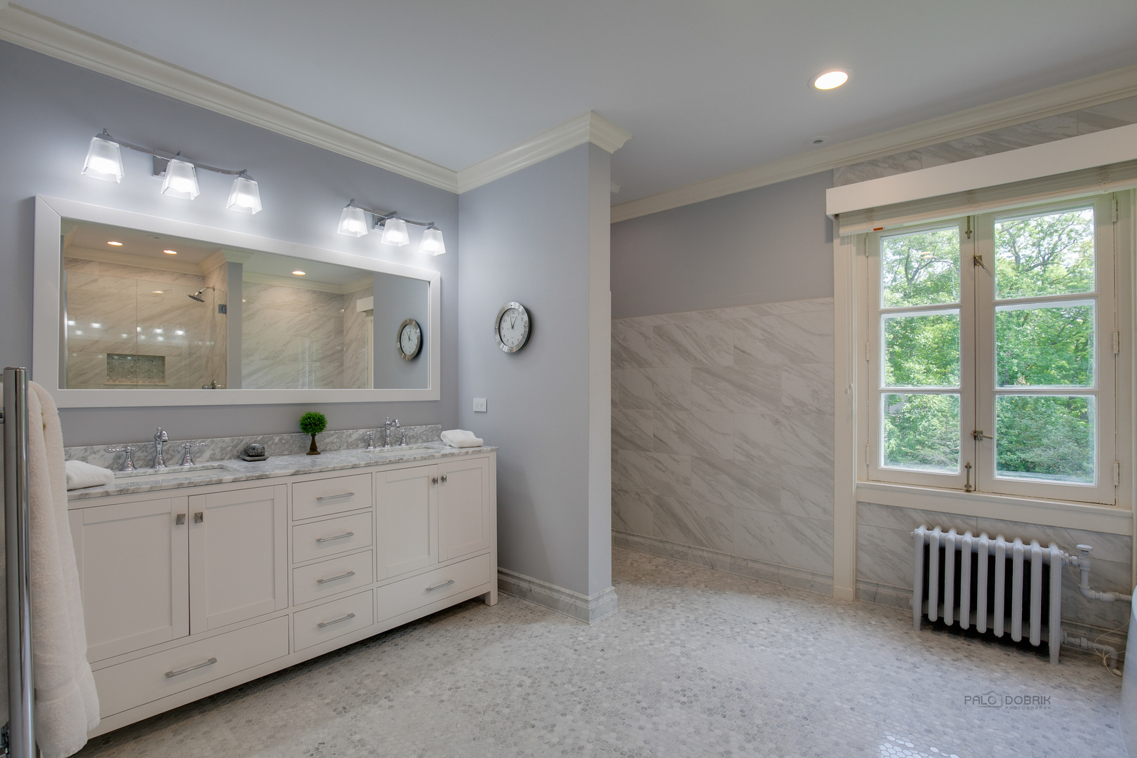 51 South Mayflower Road Lake Forest, IL 60045 - Photo 38 of 85 a bathroom with a double vanity sink a two mirror a window and a bathtub