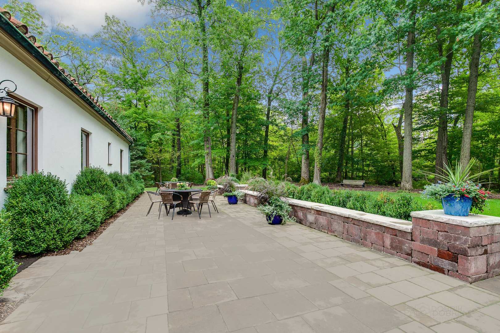 51 South Mayflower Road Lake Forest, IL 60045 - Photo 65 of 85 a view of a patio with a table and chairs and potted plants