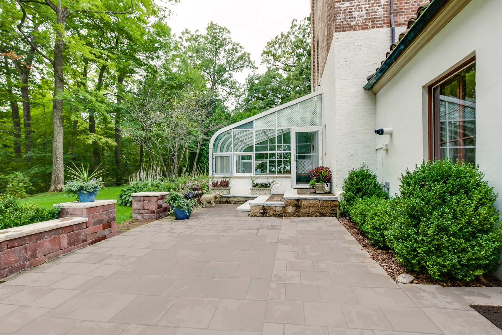 51 South Mayflower Road Lake Forest, IL 60045 - Photo 66 of 85 a view of a patio with couches and a table and chairs with wooden fence and plants