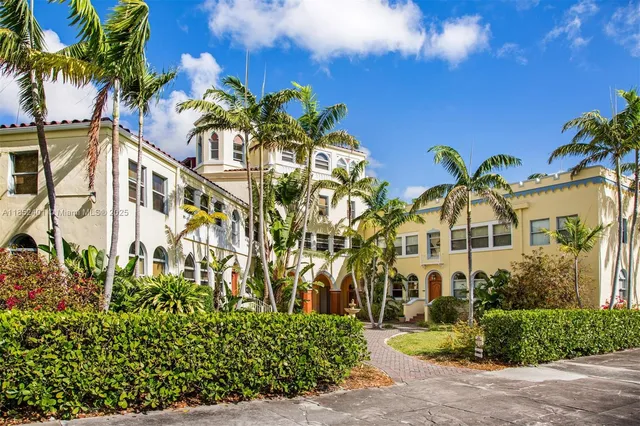 a front view of a multi story residential apartment building with a yard