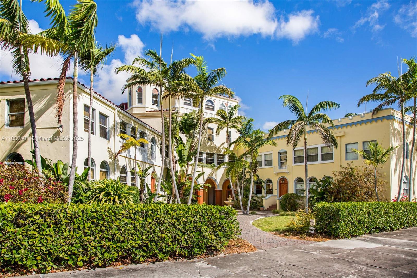 a front view of a multi story residential apartment building with a yard