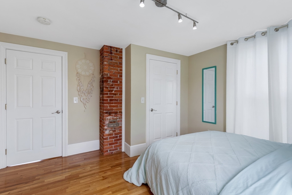 34 Warren Street, Unit 3 Stoneham, MA 02180 - Photo 17 of 34 a bedroom with a bed and a window