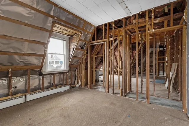 a view of walk in closet with clothes