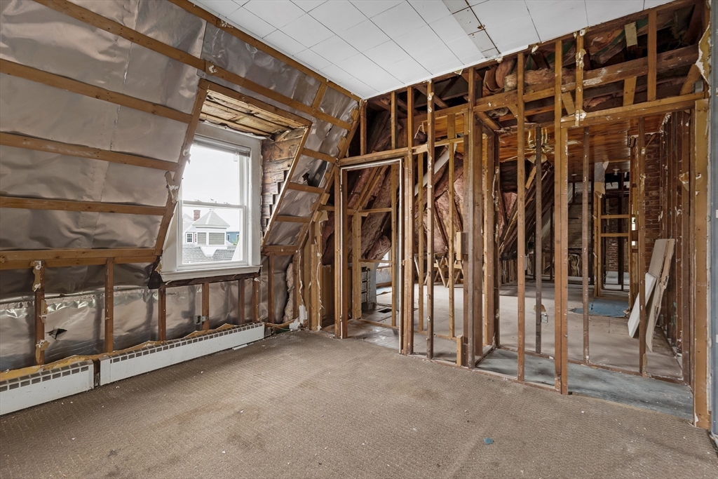 34 Warren Street, Unit 3 Stoneham, MA 02180 - Photo 26 of 34 a view of walk in closet with clothes