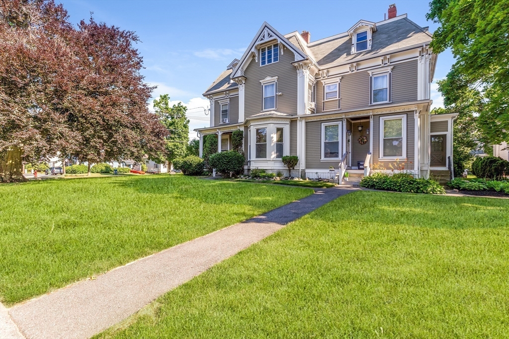 34 Warren Street, Unit 3 Stoneham, MA 02180 - Photo 3 of 34 a front view of a house with a yard