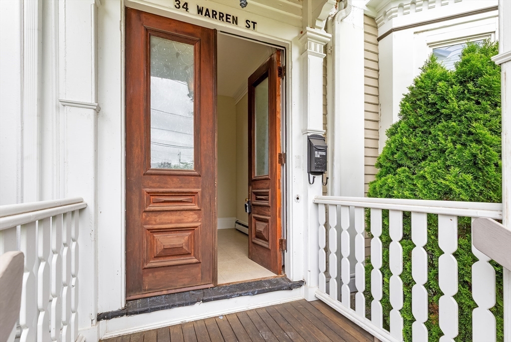 34 Warren Street, Unit 3 Stoneham, MA 02180 - Photo 32 of 34 a view of a wooden house with a glass door