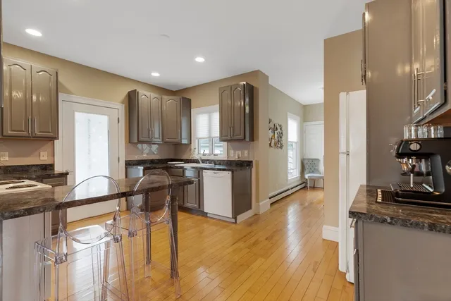 a kitchen with stainless steel appliances granite countertop a refrigerator and a stove top oven