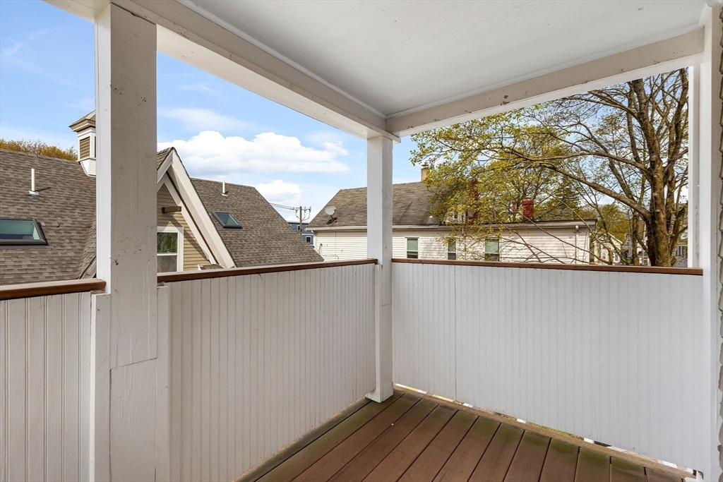 34 Warren Street, Unit 3 Stoneham, MA 02180 - Photo 9 of 34 a view of a balcony with wooden floor and fence