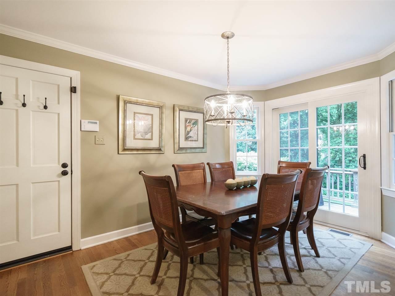 7405 Glendower Road Raleigh, NC 27613 - Photo 11 of 25 a view of a dining room with furniture window and wooden floor