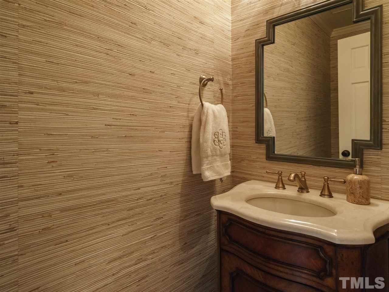 7405 Glendower Road Raleigh, NC 27613 - Photo 13 of 25 a bathroom with a sink and a mirror