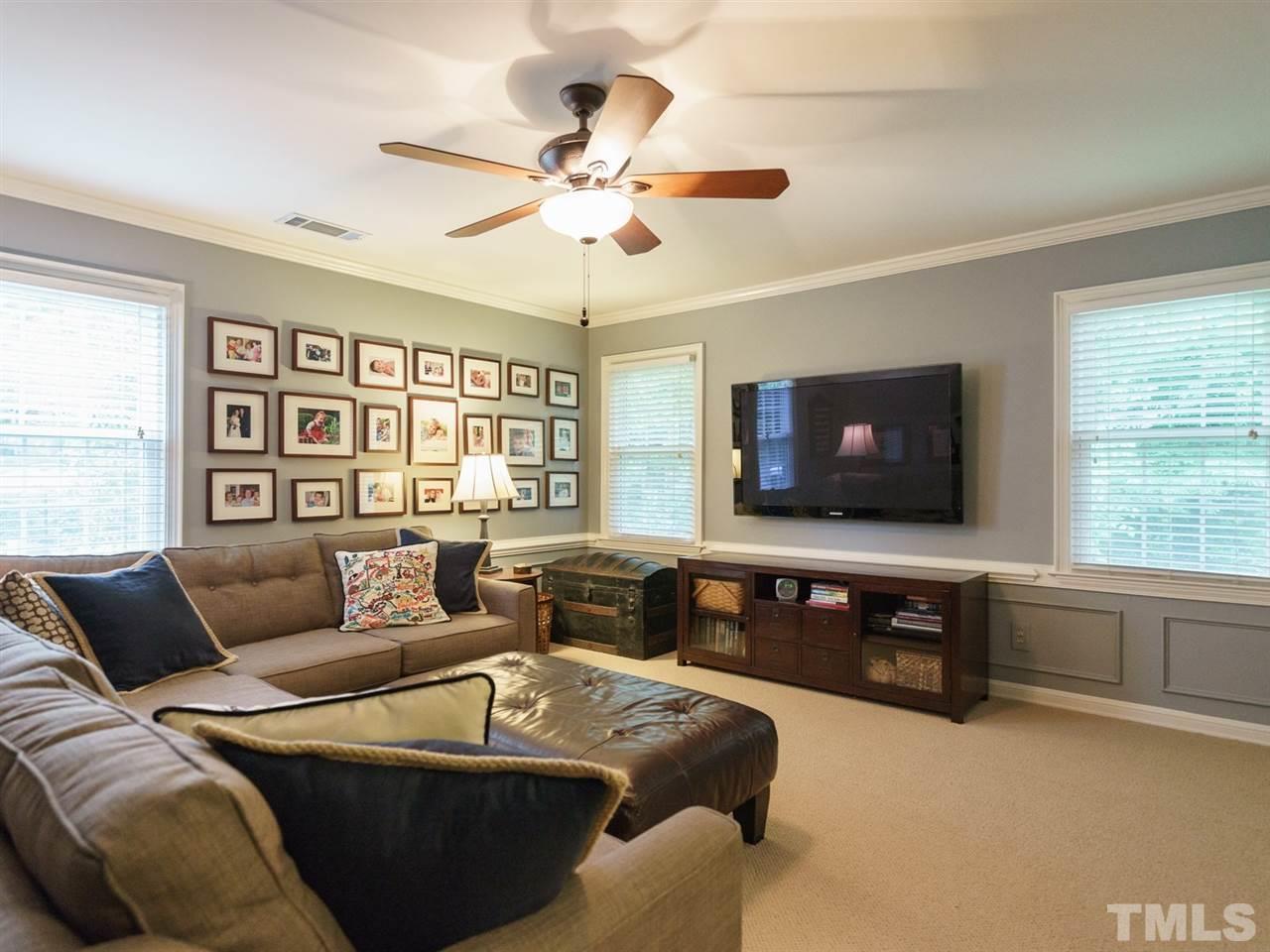7405 Glendower Road Raleigh, NC 27613 - Photo 19 of 25 a living room with furniture and a flat screen tv