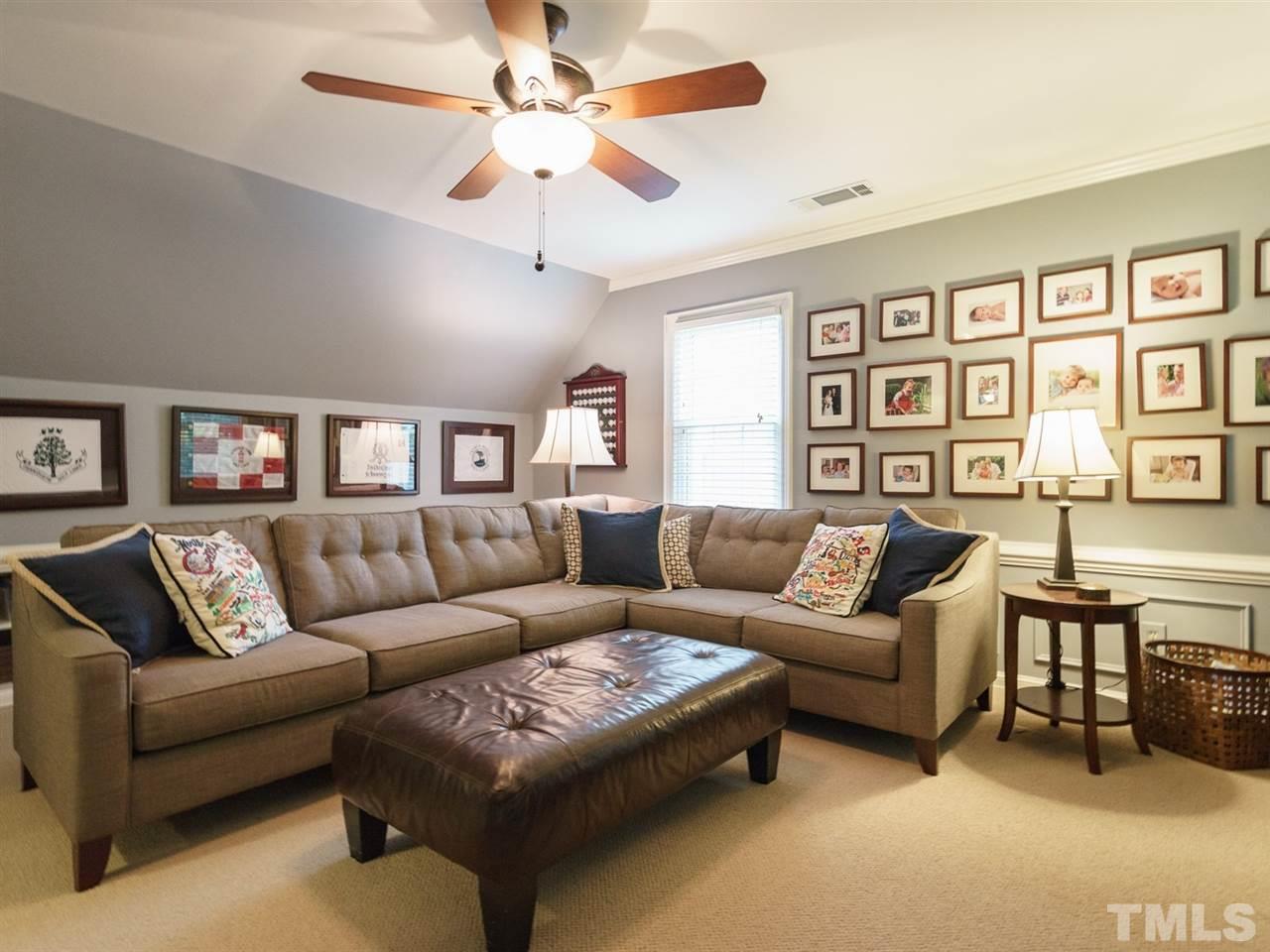 7405 Glendower Road Raleigh, NC 27613 - Photo 20 of 25 a living room with furniture and a large window