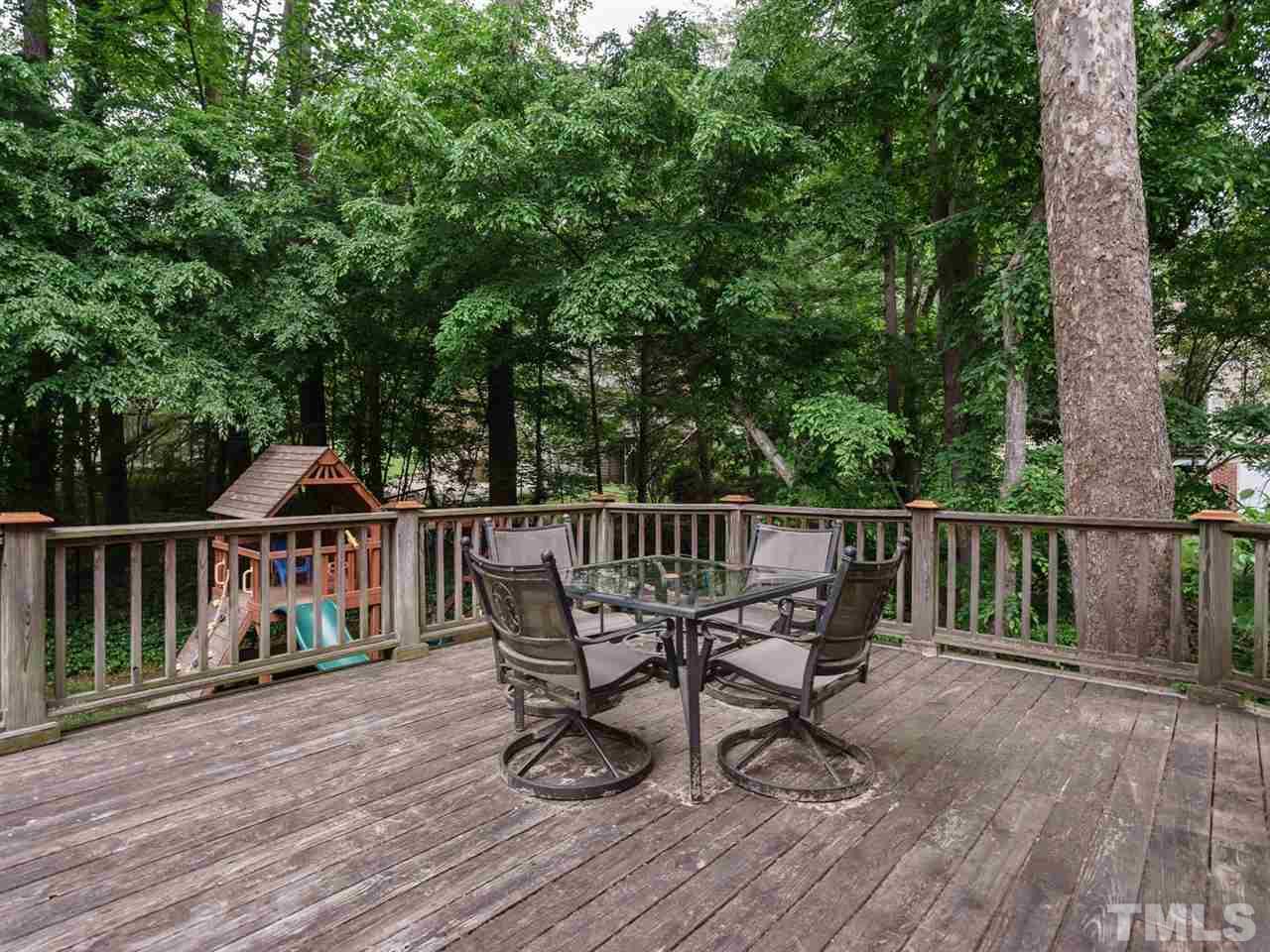 7405 Glendower Road Raleigh, NC 27613 - Photo 21 of 25 a view of a deck with two chair and wooden floor