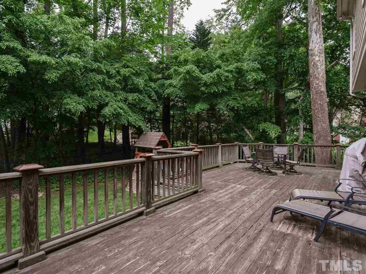 7405 Glendower Road Raleigh, NC 27613 - Photo 22 of 25 a view of a roof deck with wooden floor and fence