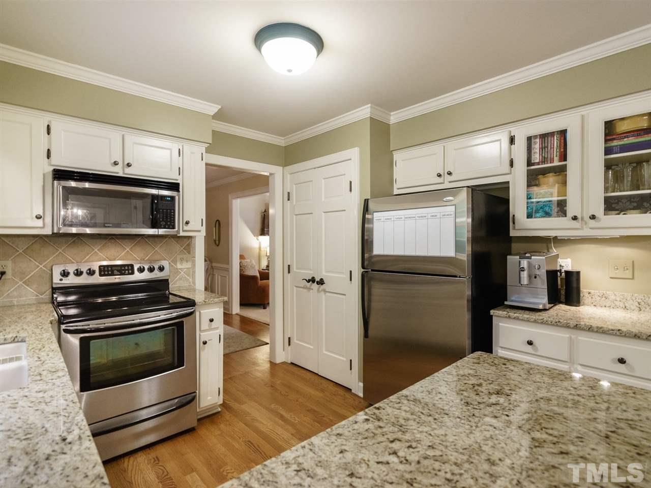 7405 Glendower Road Raleigh, NC 27613 - Photo 9 of 25 a kitchen with a refrigerator stove and microwave