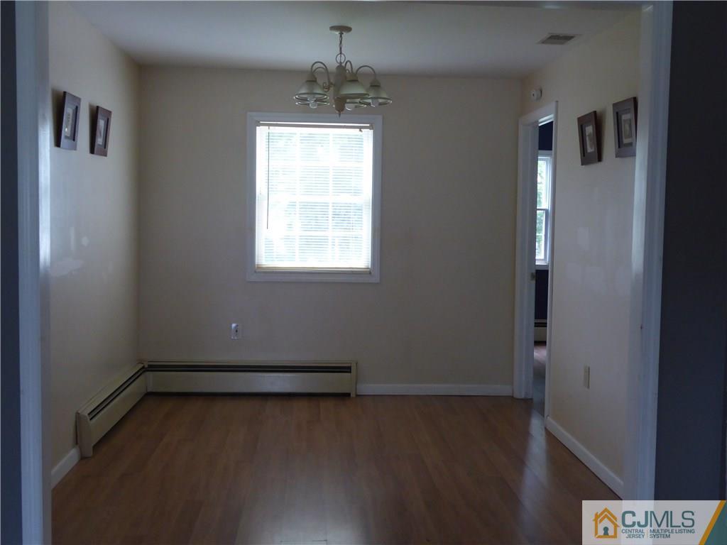 38 Stony Road West Edison, NJ 08817 - Photo 11 of 42 an empty room with wooden floor and windows