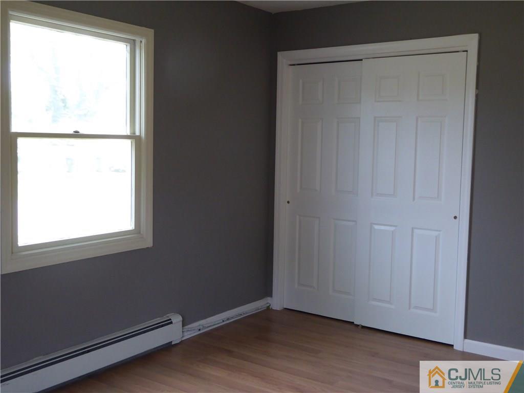 38 Stony Road West Edison, NJ 08817 - Photo 14 of 42 a view of an empty room with wooden floor and a window