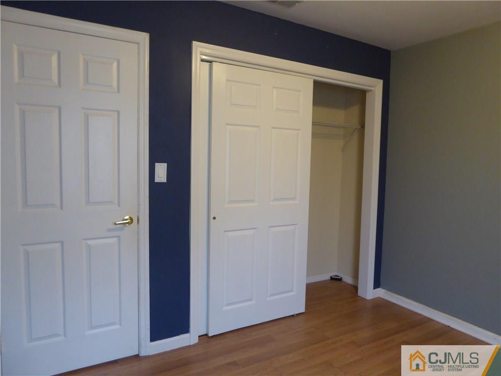38 Stony Road West Edison, NJ 08817 - Photo 17 of 42 an empty room with wooden floor and closet area