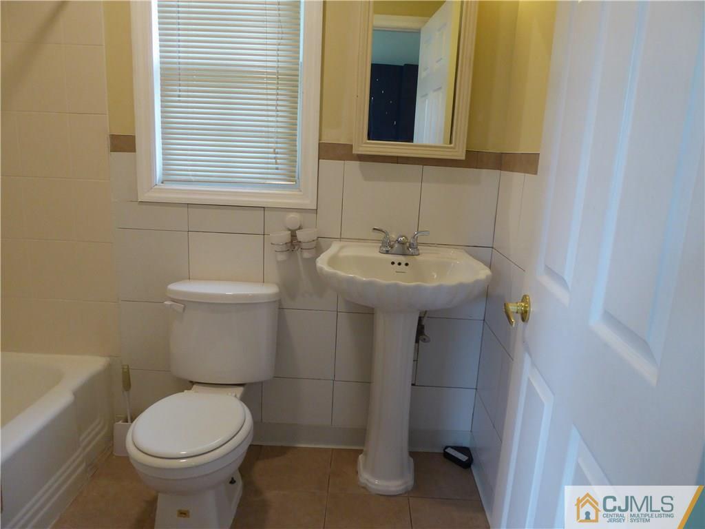 38 Stony Road West Edison, NJ 08817 - Photo 26 of 42 a bathroom with a sink toilet and a mirror